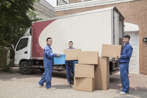 Helper carrying household items for a man and van job in Ealing