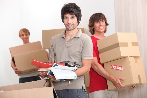 Furniture removals team working with household items in Ealing